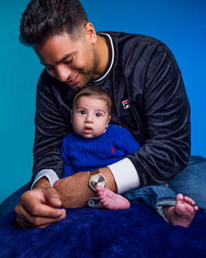 Father holding toddler son on his lap